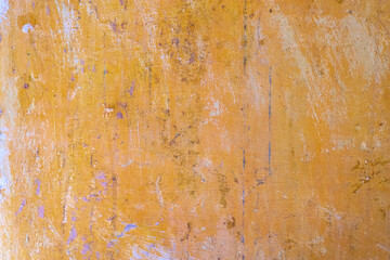 Background of old yellow painted wall. Old paint on a concrete wall