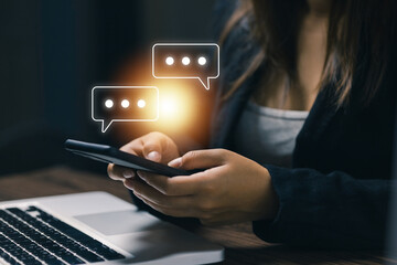 Close-up of woman using smartphone with chat bubble holograms, symbolizing instant messaging, online communication, social media interaction, and digital connectivity in modern lifestyle.