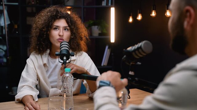 Influencer woman discussing and interviewing in a podcast studio