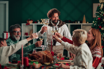 Family toasting during christmas dinner at home