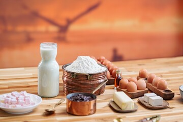 A charming culinary scene unfolds with ingredients set out on a wooden table, ready to bake a delicious homemade Cozonac or Babka