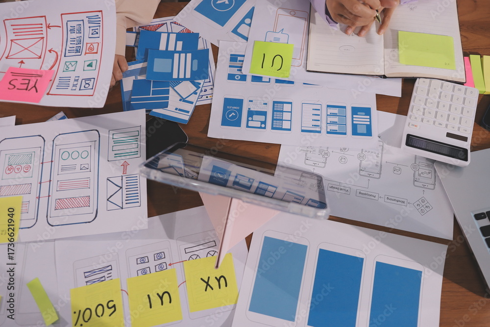 Wall mural close up ux developer and ui designer brainstorming about mobile app interface wireframe design on t