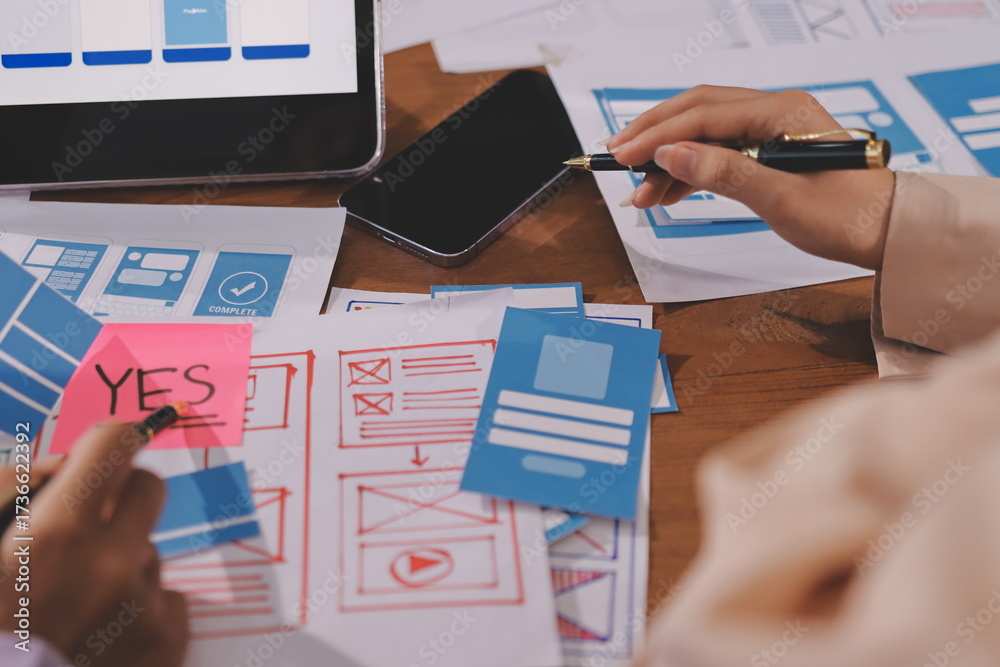 Wall mural close up ux developer and ui designer brainstorming about mobile app interface wireframe design on t
