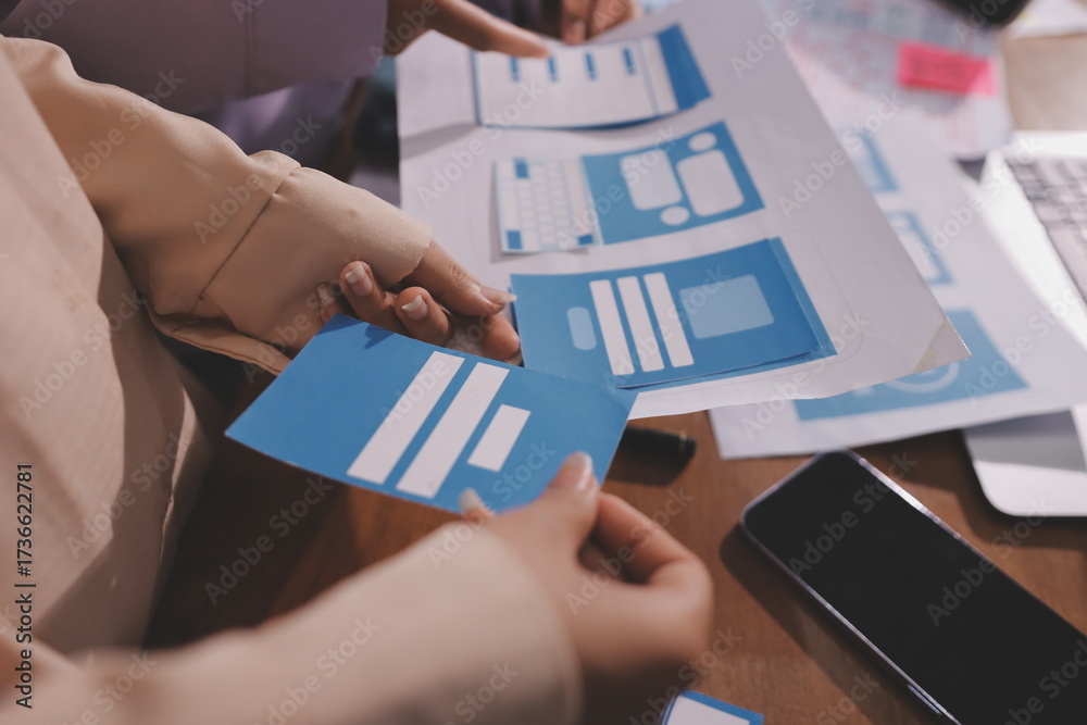 Wall mural close up ux developer and ui designer brainstorming about mobile app interface wireframe design on t