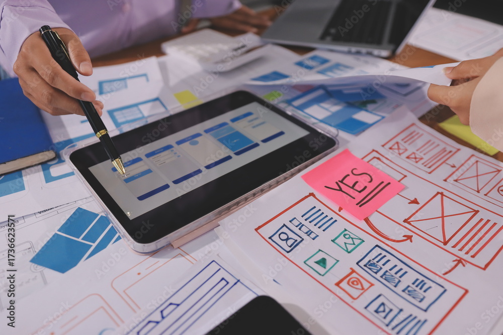 Wall mural close up ux developer and ui designer brainstorming about mobile app interface wireframe design on t