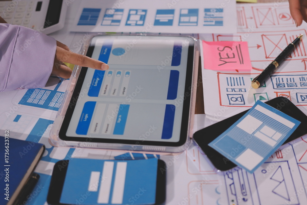 Wall mural close up ux developer and ui designer brainstorming about mobile app interface wireframe design on t