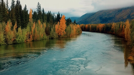 Scenic river flowing through a vibrant autumn forest with mountains in the background