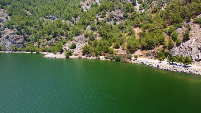 Drone footage capturing the breathtaking aerial panorama of Iztuzu Beach, also known as Turtle Beach, in Dalyan, Turkey. This stunning natural wonder, a protected nesting ground for loggerhead sea tur