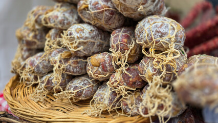 Pile of tasty salami sausages piled on a street market stall in France.