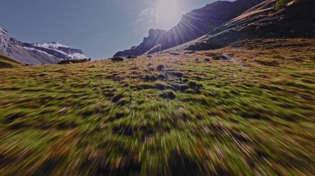 An extremely close flyby of a mountain cliff with an FPV drone at high speed on a sunny day. High-speed quadcopter and UAV flights in the mountains.