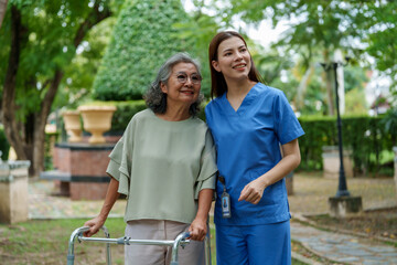 Caring caregiver provides assistance and support to senior in serene outdoor setting, showcasing importance of companionship and care in daily life