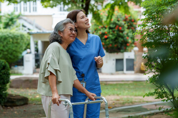 Caring caregiver provides assistance and support to senior in beautiful garden setting, showcasing importance of companionship and care in daily life