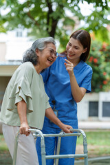 Caring caregiver provides assistance and support to senior in need of care, fostering joyful moment filled with laughter and connection in serene outdoor setting