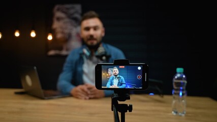 Influencer recording podcast video with smartphone - Powered by Adobe