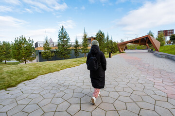 Enjoy a calming stroll along a picturesque park path, surrounded by vibrant greenery and lush plants that foster tranquility and relaxation, offering a perfect escape from daily life