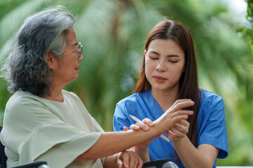Caring caregiver provides assistance and support to senior in need of care, fostering warm connection in serene outdoor setting