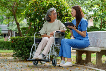 Caregiver provides assistance and support to senior in park, fostering caring environment. interaction highlights importance of companionship in senior care