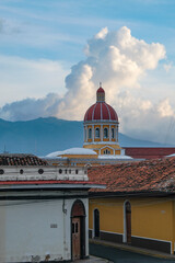 Granada, Nicaragua - September 28, 2025: Our Lady of the Assumption Cathedral with the Mombacho Volcano in the background in Granada, Nicaragua.
