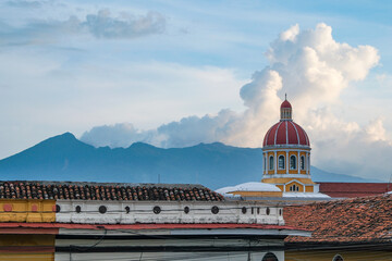 Granada, Nicaragua - September 28, 2025: Our Lady of the Assumption Cathedral with the Mombacho Volcano in the background in Granada, Nicaragua.