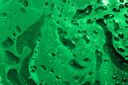 Green liquid abstract texture with bubbles and ripples