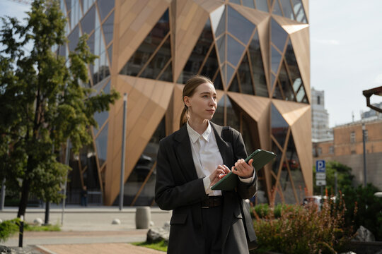 Business woman holding a tablet in urban environment