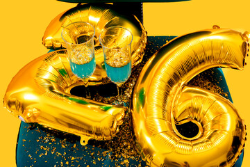 Celebration scene with golden balloons and champagne