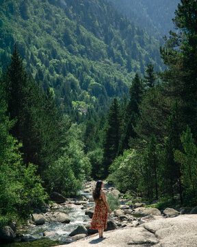 Woman enjoying nature by the river in the Pyrenees