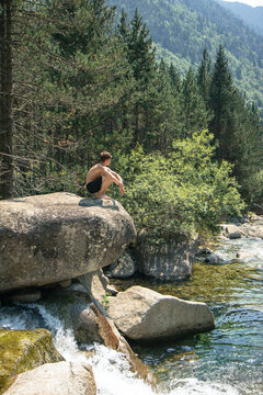 Man enjoying tranquility by the river in the Pyrenees