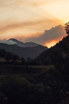Sunset over smoky Somiedo Valley landscape during wildfire