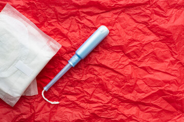 Menstrual products on a vibrant red background