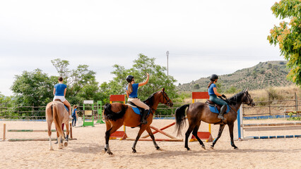 Horseback riding lesson with young riders outdoors