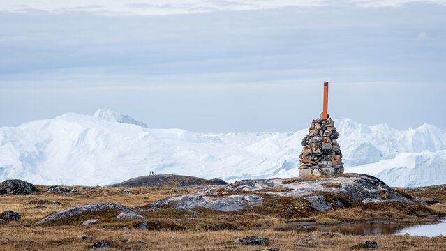 Stone cairn overlooking Ilulissat Icefjord scene
