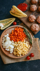 Ingredients for a hearty meal arranged on a wooden surface