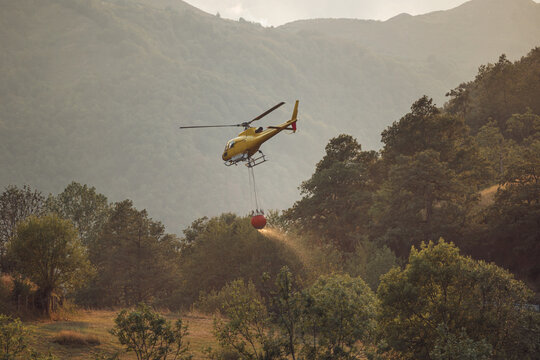 Yellow helicopter firefighting mission in spanish valley