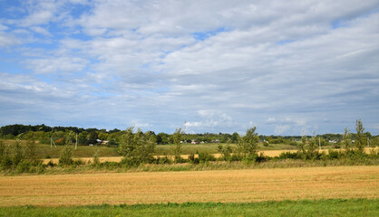 Fototapeta premium Rural outback in August - a village surrounded by fields, Russia, Central Black Earth Region