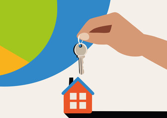 A hand is seen holding a key above a small house model, representing home ownership.