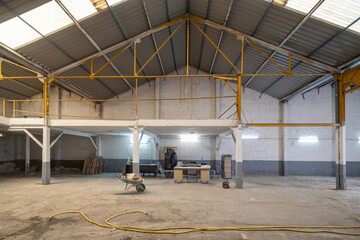 Industrial warehouse under renovation with workspace setup