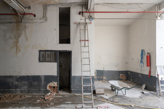 Garage under construction with ladder and debris