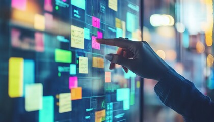 A hand is shown interacting with a digital screen that displays various colorful blocks of data and graphs.