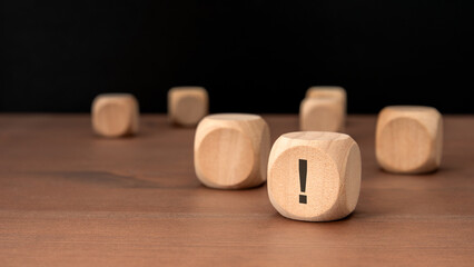 wooden cubes with exclamation marks on wooden table