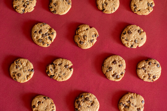 Homemade chocolate chip cookies on red surface