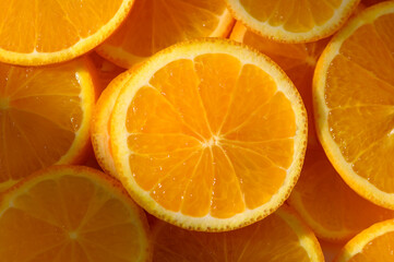 Oranges cut into slices and laid on table as food background