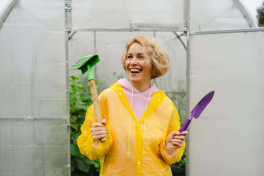 Woman in greenhouse enjoying gardening work