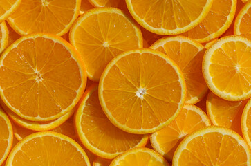 Oranges cut and arranged on table as food background