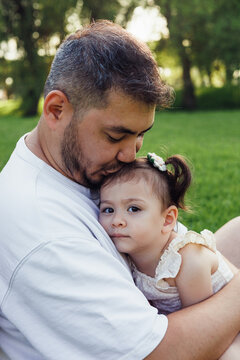 Father and daughter bonding in serene park setting