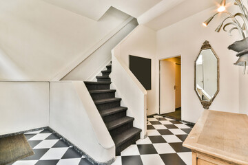 Modern hallway with staircase and geometric tile floor