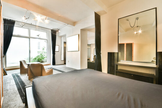 Modern bedroom with chic decor and large window