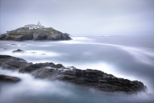 Mystic coastal view of Isla Pancha lighthouse at dawn