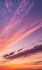 Obraz premium Vibrant pink and orange sunset sky with wispy clouds image