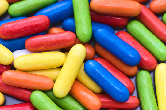 Candy-coated liquorice capsules in vibrant colors